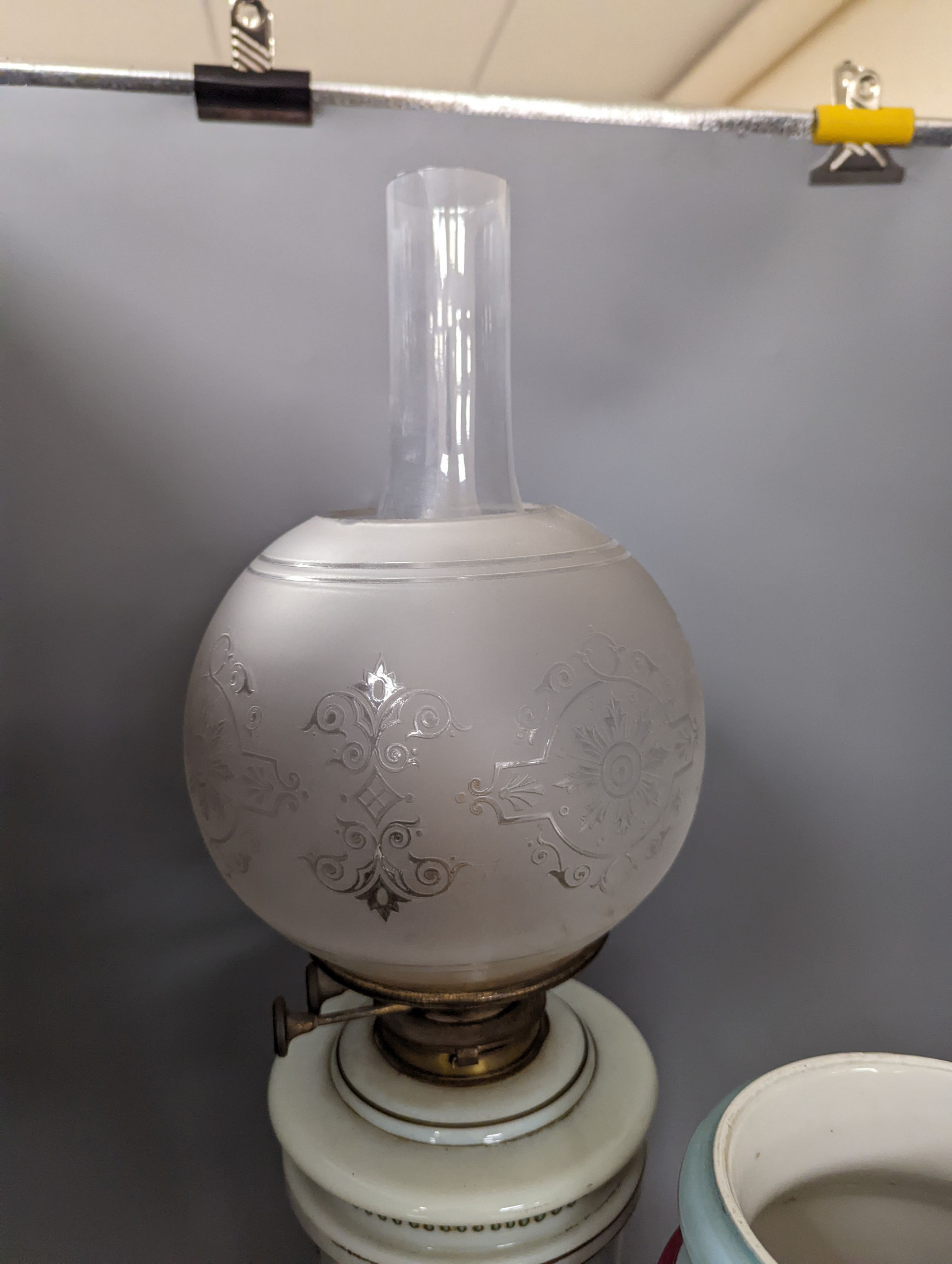 A late 19th century French enamelled green glass oil lamp and glass shade and a Paris porcelain vase, Oil lamp 61 cms high.